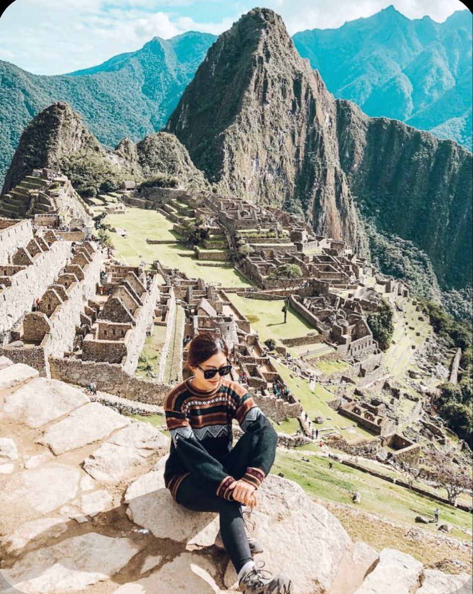 Panoramic view of Machu Picchu with surrounding green mountains