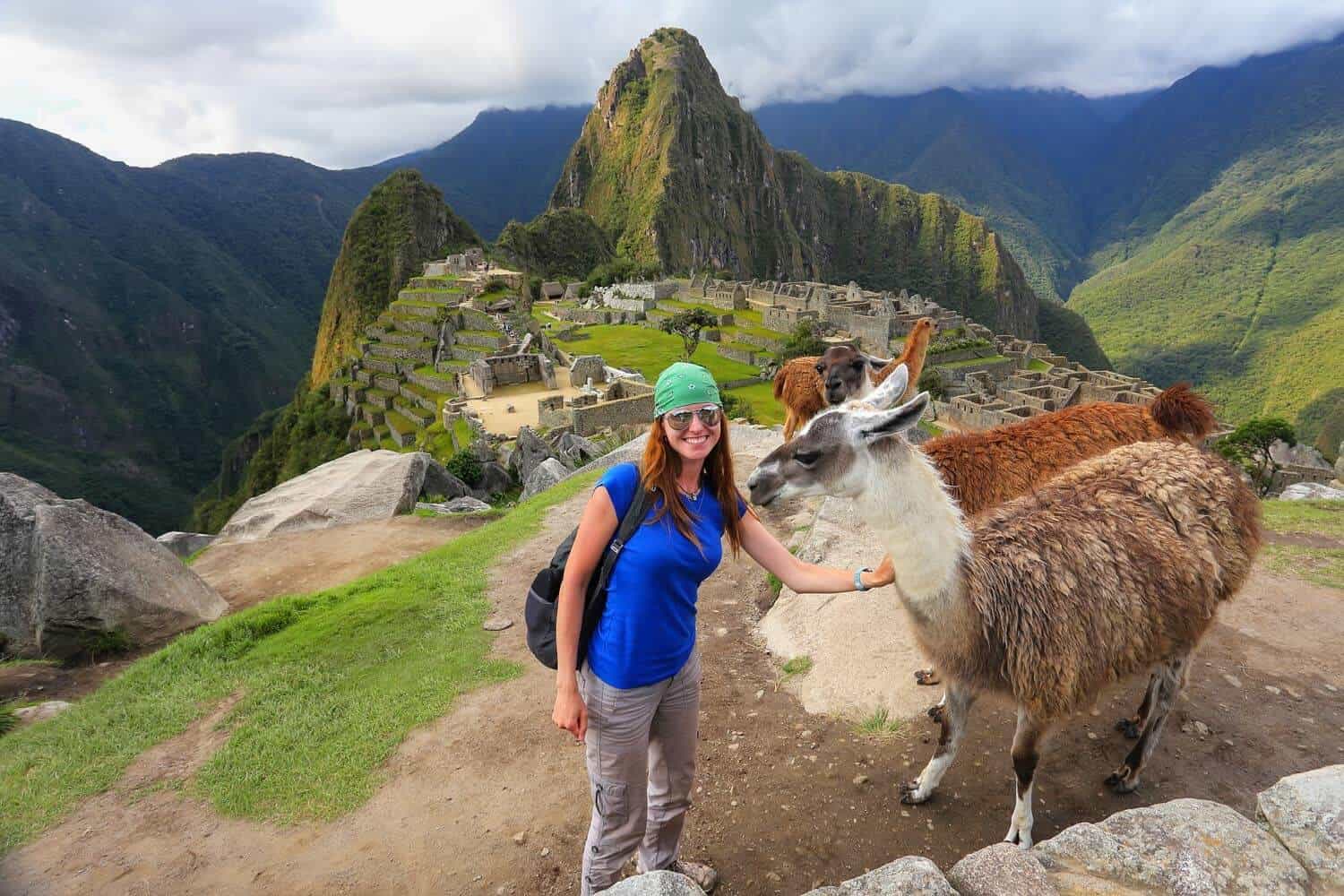 Classic view of Machu Picchu citadel with tourists on terraces